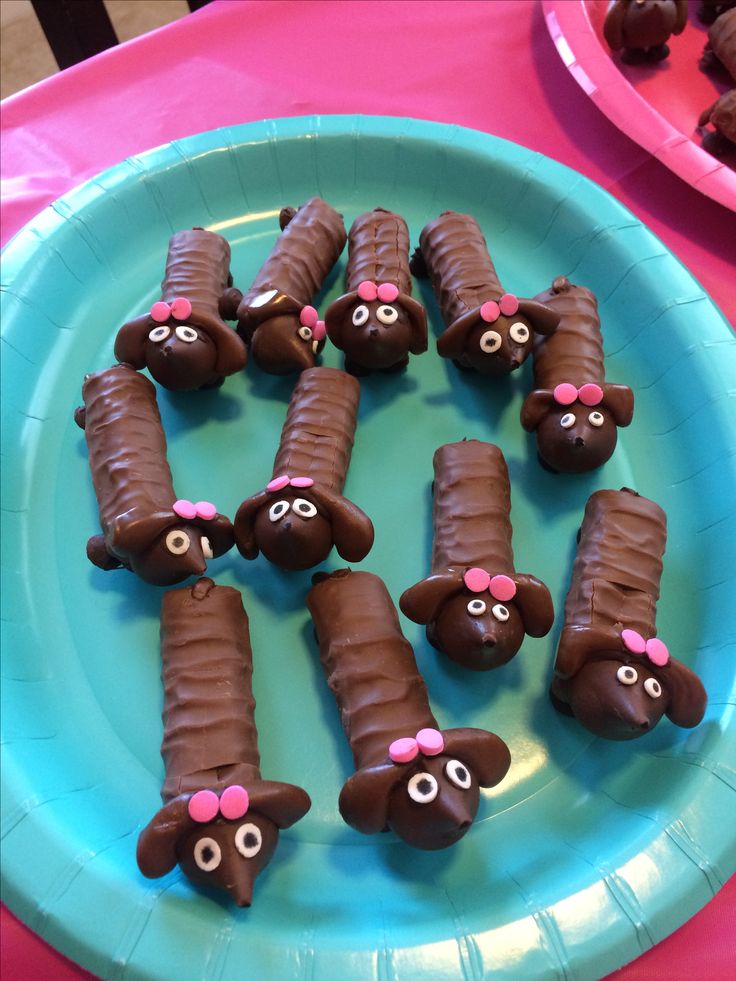 there are many chocolate dogs on the plate