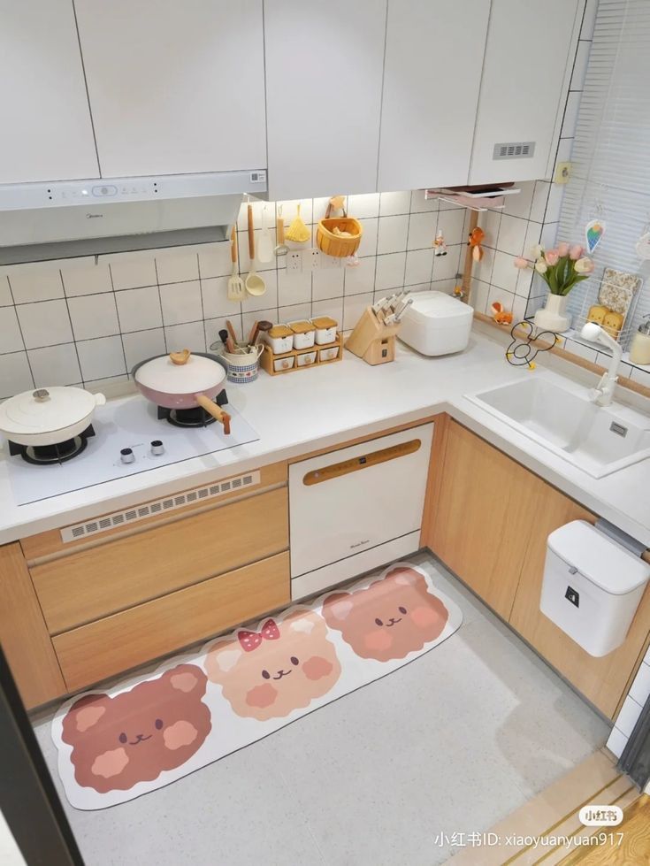 a kitchen with wooden cabinets and white countertops has teddy bears rugs on the floor