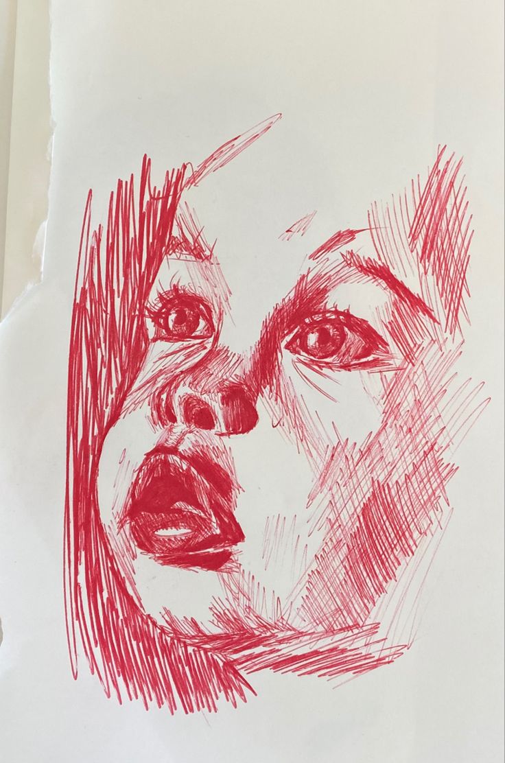 a drawing of a woman's face with red crayon pencils on paper