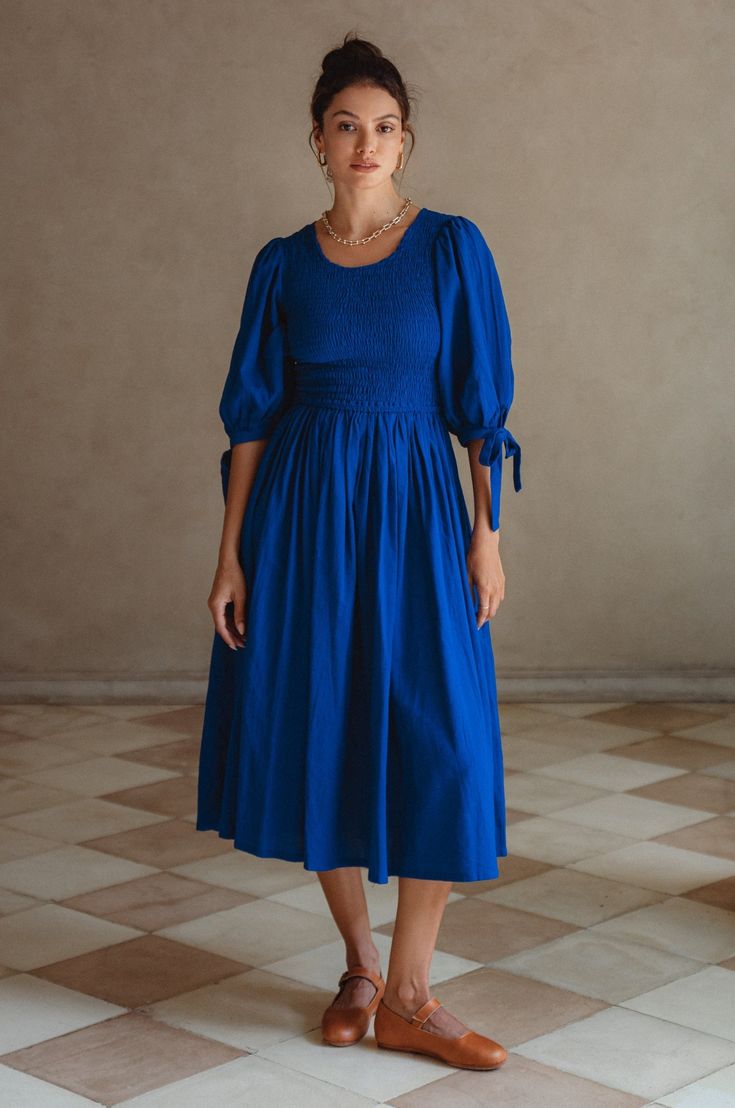 Midi Smocked Dress For Gatherings, Casual Ruched Smocked Dress For Gatherings, Midi Dress With Gathered Neckline For Gatherings, Elegant Smocked Ruched Billowy Dress, Elegant Billowy Smocked Ruched Dress, Elegant Billowy Smocked Dress With Ruched Details, Knee-length Smocked Dress With Gathered Sleeves For Brunch, Fitted Midi Peasant Dress With Smocked Back, Fitted Midi Length Peasant Dress With Smocked Back