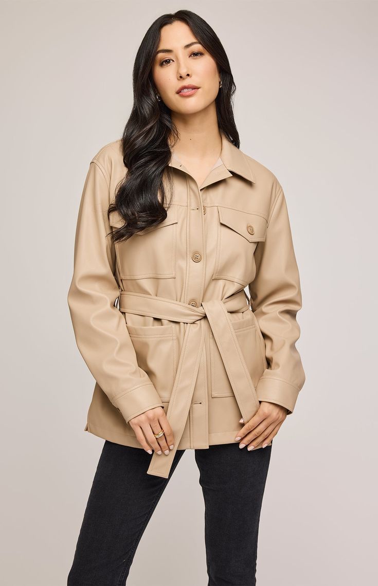 The Grenadine jacket is made of a soft faux leatherette and is fully lined for ease of wear. Features include patch pockets, side slits, and a removable belt for styling versatility. Beige Leather Outerwear With Lapel Collar, Trendy Fall Outerwear With Belt Loops, Trendy Belted Outerwear For Work, Trendy Outerwear With Belt Loops For Fall, Leather Utility Jacket With Flap Pockets For Work, Spring Faux Leather Belted Outerwear, Leather Jacket With Belted Cuffs, Chic Utility Jacket With Flap Pockets For Fall, Belted Beige Outerwear For Office