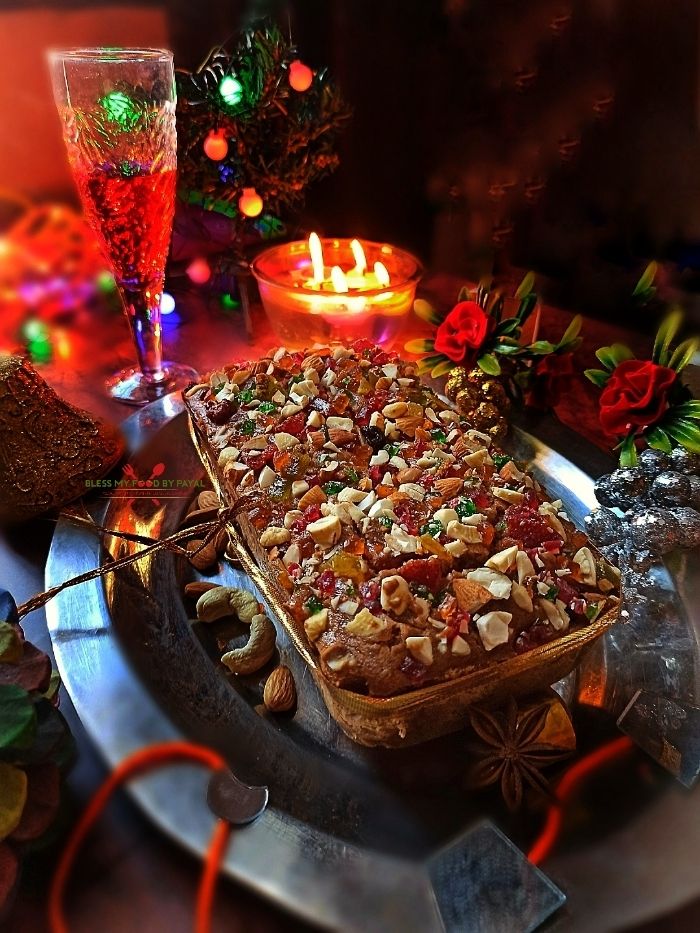 a table topped with lots of food next to a glass filled with wine and candles