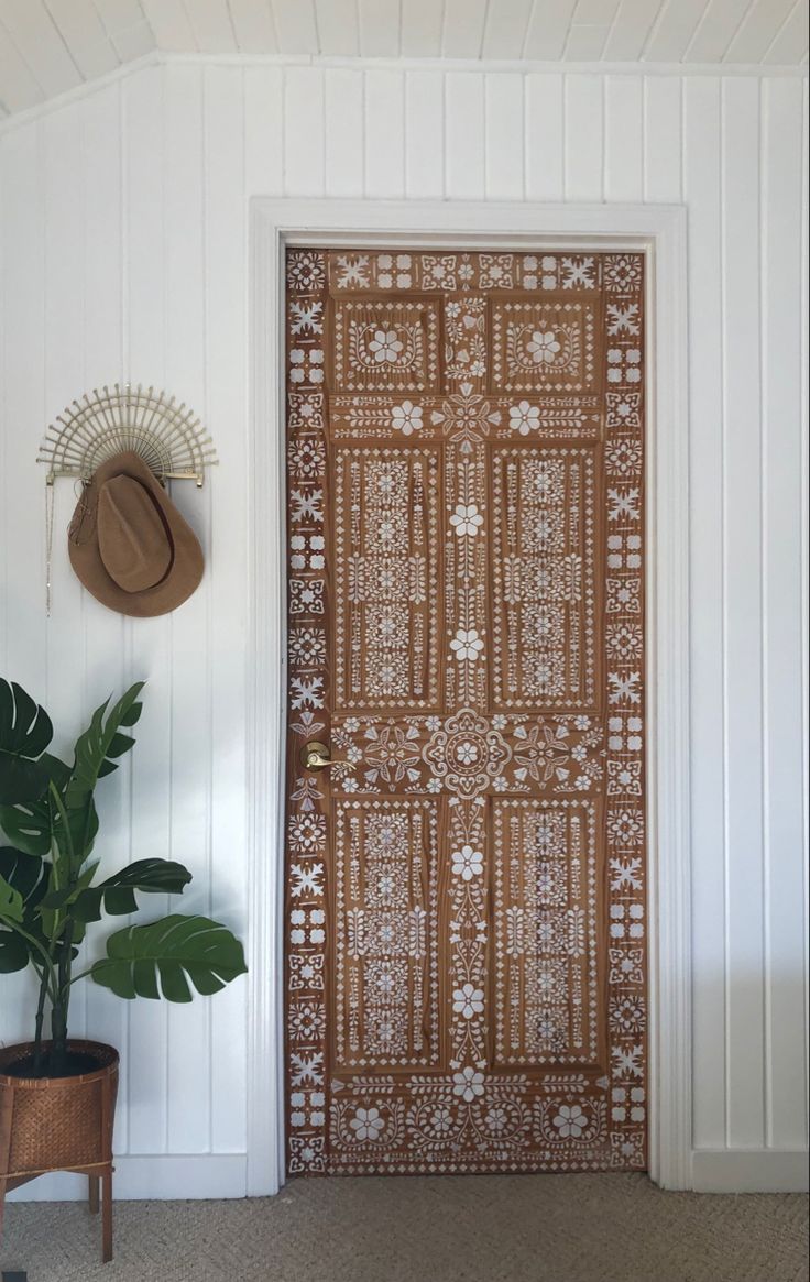 the door is decorated with an intricate pattern and has a hat on it's head