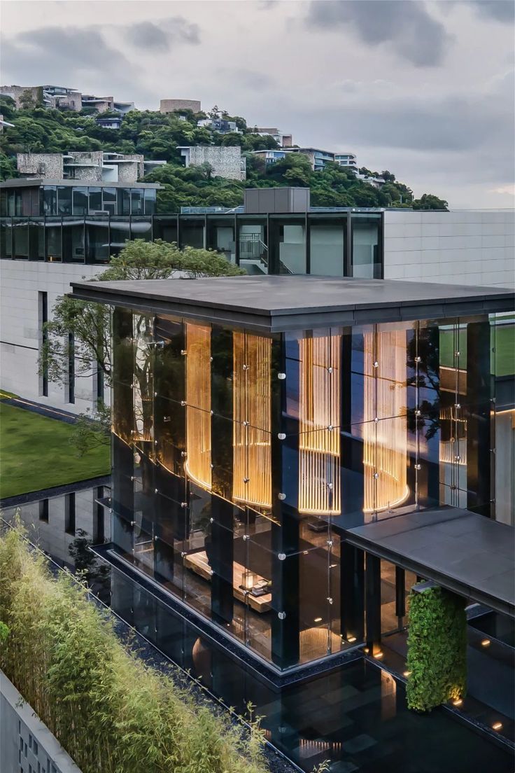 an aerial view of a modern building with green roofing and trees on the other side