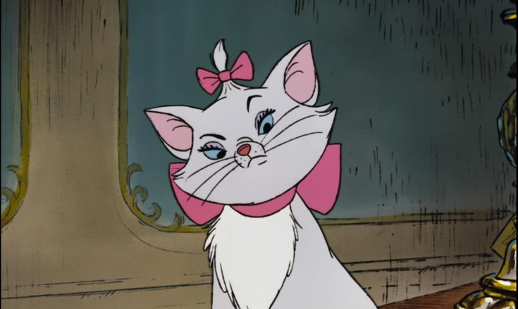 an animated image of a cat with a bow on it's head sitting in front of a mirror