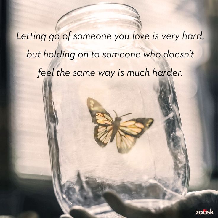 a person holding a glass jar with a butterfly in it and the words letting go of someone you love is very hard, but holding on to someone who doesn't