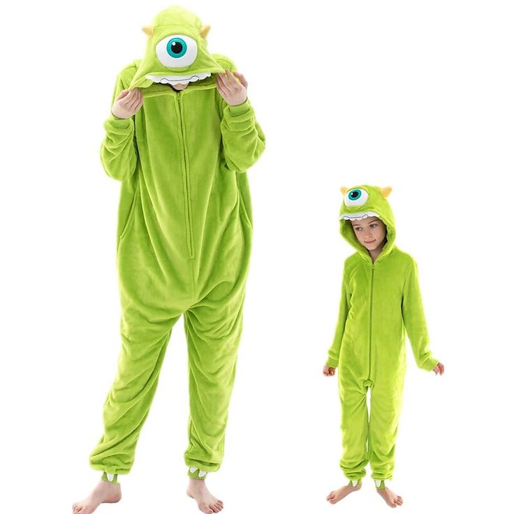 two children in green onesuits with eyes on them