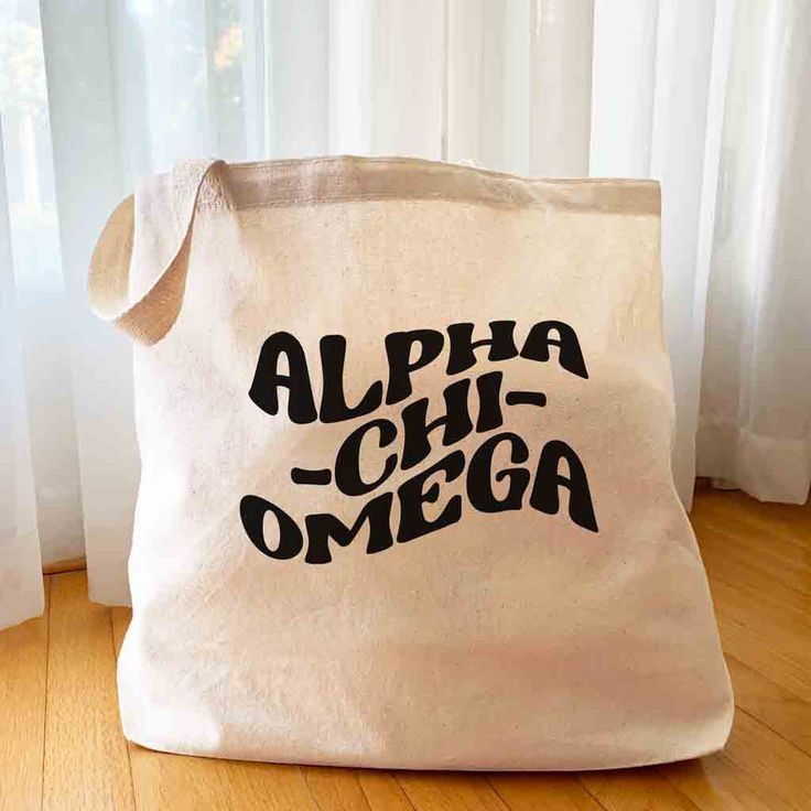 a canvas bag with the word'alpha chi - omega'printed on it