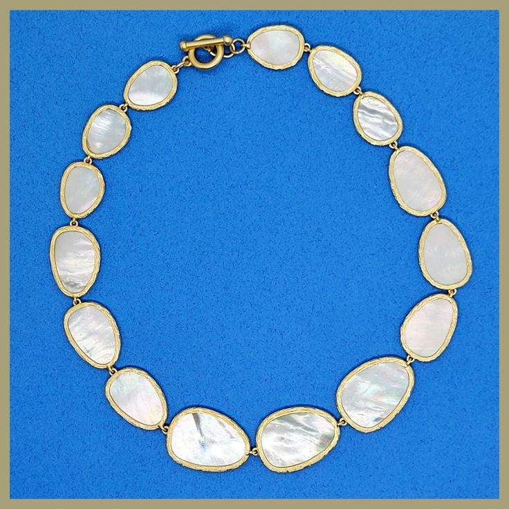 An iconic design, beautiful and timeless. Graduated, irregularly shaped petals of mother-of-pearl, each surrounded by a brushed golden edge. The natural mother-of-pearl nacre has a lustrous sheen that contains a rainbow of colors, changing with the light. Lightweight and delicate, and perfectly proportioned. Toggle clasp for easy on/off. 16" long, with petals that range from 3/4" to 1.25" in length. Imported for the Leila Jewels Glam Collection Elegant Shell-shaped Pearl Drop Necklace, Elegant Gold Shell Necklace With Pearl Drop, Formal Necklace With High Luster Mother Of Pearl, Formal Mother Of Pearl Necklace With High Luster, Elegant Jewelry With Oyster Bracelet, Oval Mother Of Pearl Gold Necklace, Gold Oval Mother Of Pearl Necklace, Gold Oval Necklace With Mother Of Pearl, White Polished Mother Of Pearl Necklace