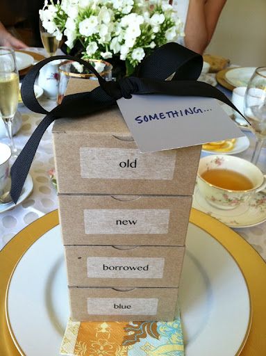 there is a small box on top of the table with some tea and flowers in it