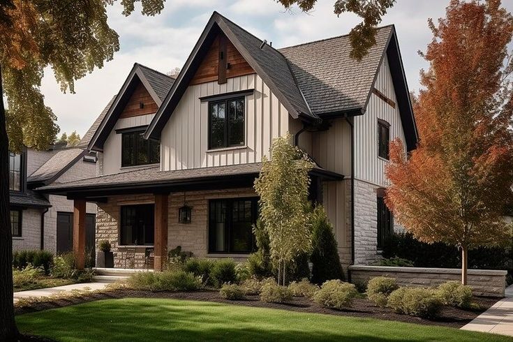 a large house with lots of windows in the front yard and landscaping on both sides