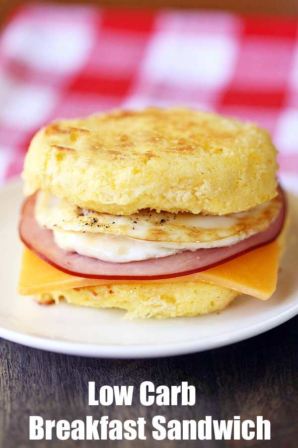 an egg sandwich with ham and cheese on a white plate