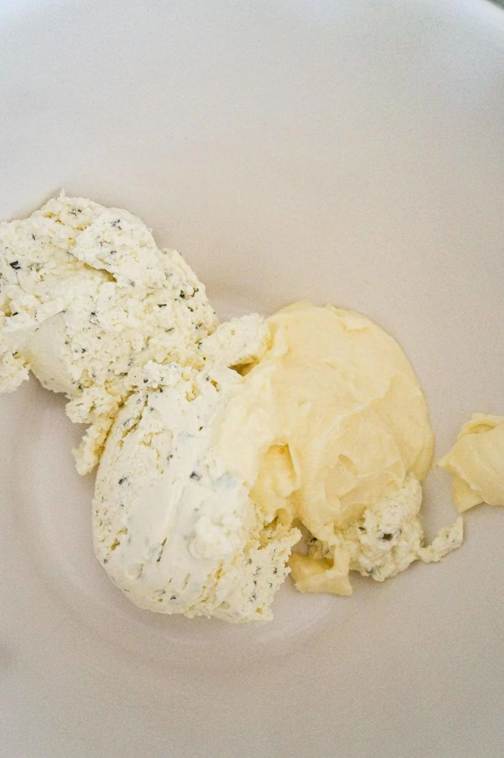 an ice cream scoop in a bowl with some sort of substance on it's surface