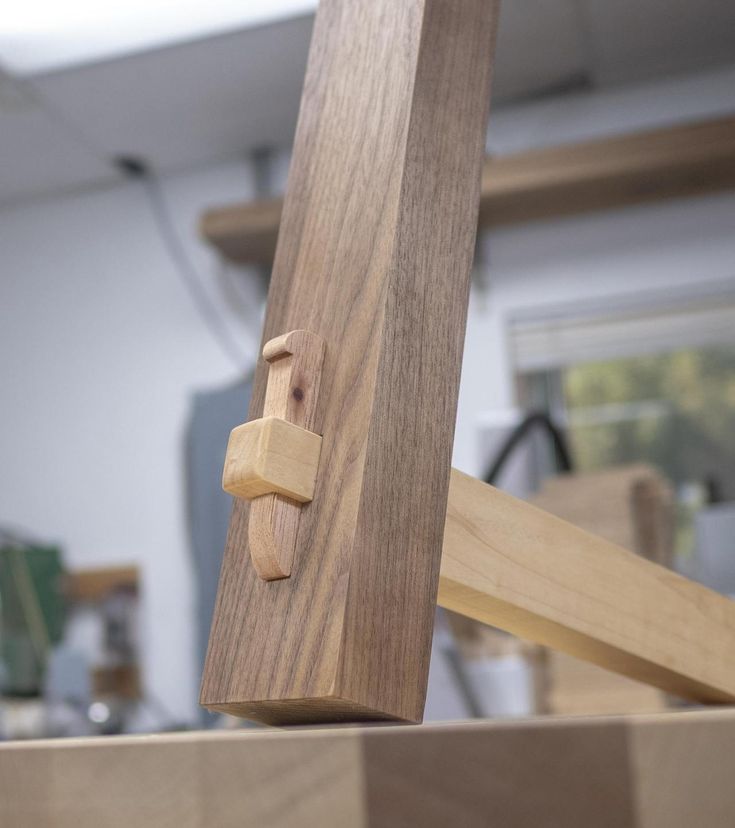 a close up of a piece of wood with a wooden handle on the top of it