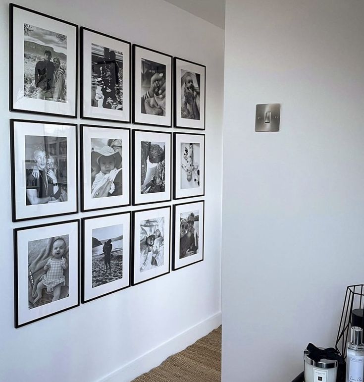 black and white photographs are hanging on the wall