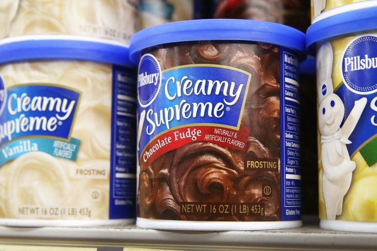 three tubs of creamy supreme ice cream are on display in a grocery store's deli