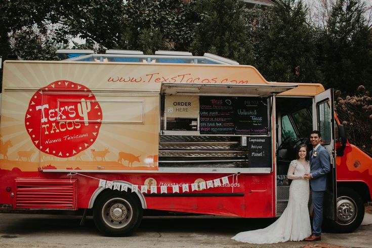 a man and woman standing in front of a food truck that sells tex tacos