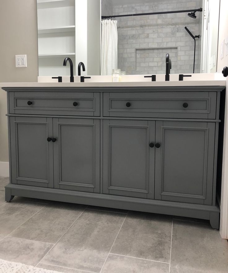 a bathroom with two sinks and a large mirror