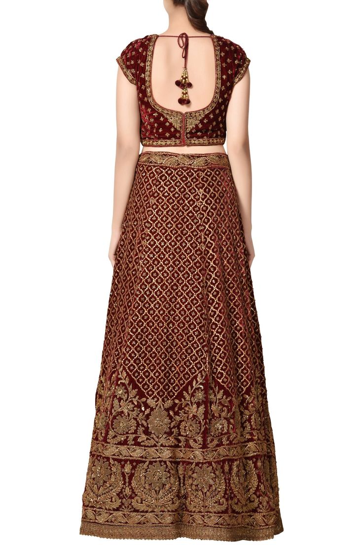 Rich and plush velvet fabric combine with antique gold zardozi embroidery and sequin work all over this lehenga, forming the perfect traditional ensemble to flaunt at your wedding. The lehenga comes along with a short sleeve blouse and a sheer heavy border dupatta for the full look. Elegant Gold Velvet Lehenga, Festive Gold Velvet Lehenga, Anarkali Embroidered Fabric With Meenakari For Reception, Meenakari Embroidered Anarkali Fabric For Reception, Gold Velvet Lehenga For Wedding, Reception Meenakari Dola Silk Choli, Velvet Saree With Pallu For Wedding, Velvet Saree Set With Zari Work, Festive Velvet Lehenga