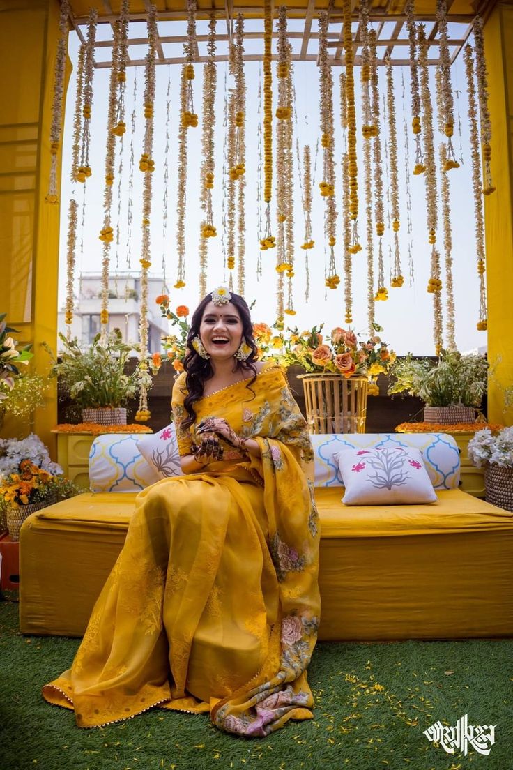 a woman sitting on top of a yellow couch