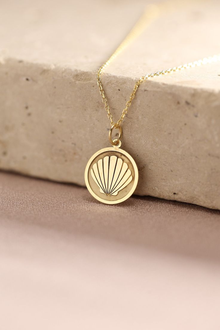 Gold Seashell Pendant - Seashell Gold Necklace ● Material of pendant: Solid Gold 14k ( REAL GOLD ) ● Metal Stamp: 14k ( REAL GOLD ) ● The pendant is available in 5 sizes: - 12,7 mm / 0.5 inches (Diameter) - 14,0 mm / 0,55 inches ( Diameter ) In the photos - 15,3 mm / 0.6 inches ( Diameter ) - 16,5 mm / 0,65 inches ( Diameter ) - 19,1 mm / 0,75 inches ( Diameter ) ( In the photos the size is 14mm / 0.55 inches Diameter ) ( Jump Ring inner diameter: 4 mm ) ● Material of chain: Solid gold 14k ( REA Pendant Shell Necklace With Lobster Clasp As Gift, Shell Necklace With Clavicle Chain As Gift, Shell Necklace With Clavicle Chain For Gift, Gift Shell Necklace With Clavicle Chain, Shell Pendant Charm Necklaces For Gifts, Yellow Gold Shell-shaped Necklace Gift, Dainty Shell Necklaces Perfect As Gifts, Elegant Shell Charm Necklace As Gift, Elegant Shell Charm Necklaces For Gift