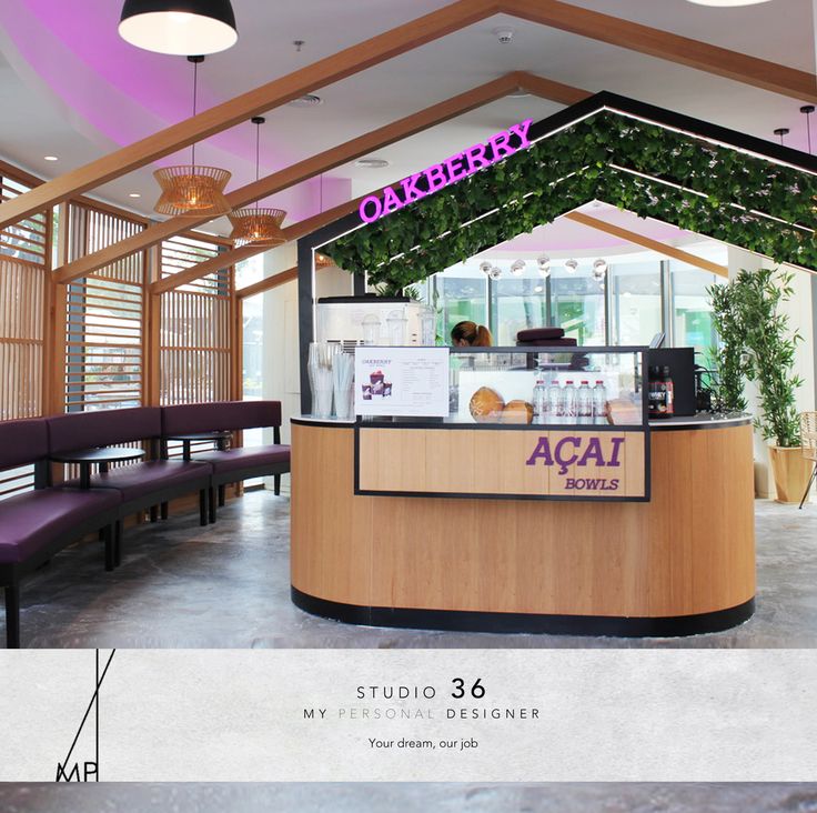 the interior of a restaurant with purple lighting and wood accents, along with an acai counter