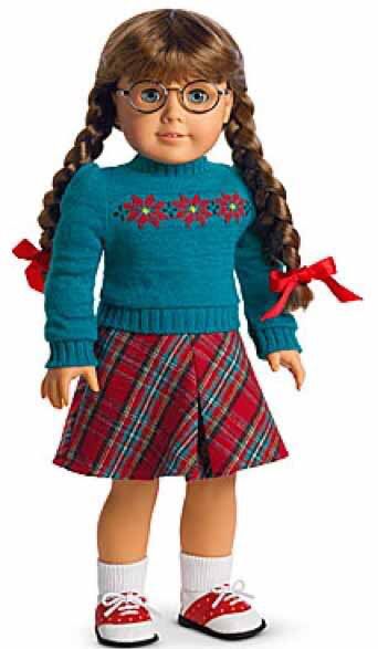 the doll is wearing glasses and a blue sweater with red bows on it's head