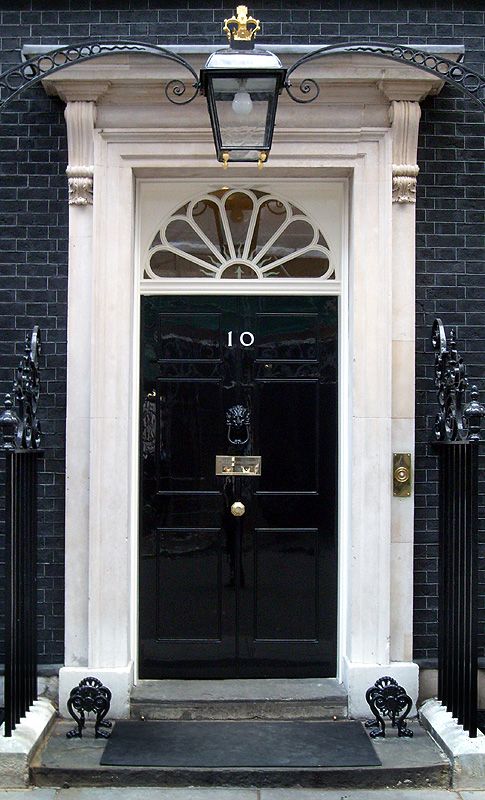 a black front door on a brick building