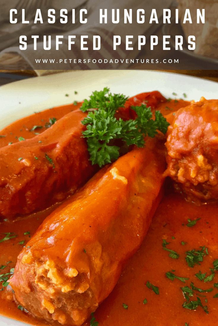 two stuffed peppers on a plate with sauce and parsley in the background text reads classic hungarian stuffed peppers