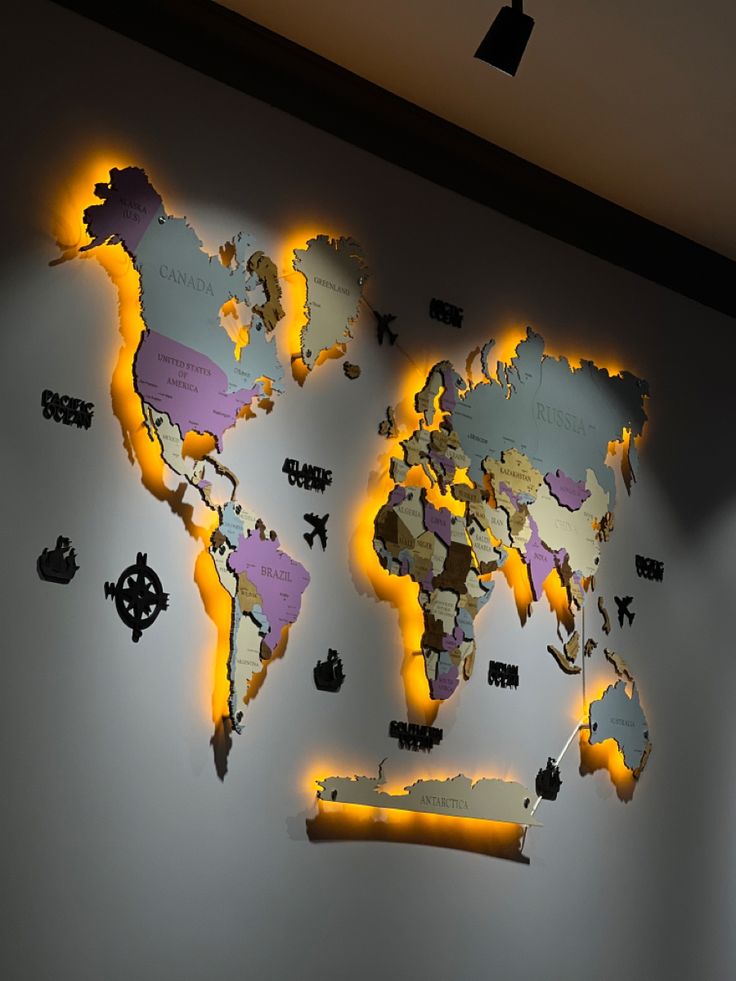 a world map is shown on the wall with yellow light coming from it's sides