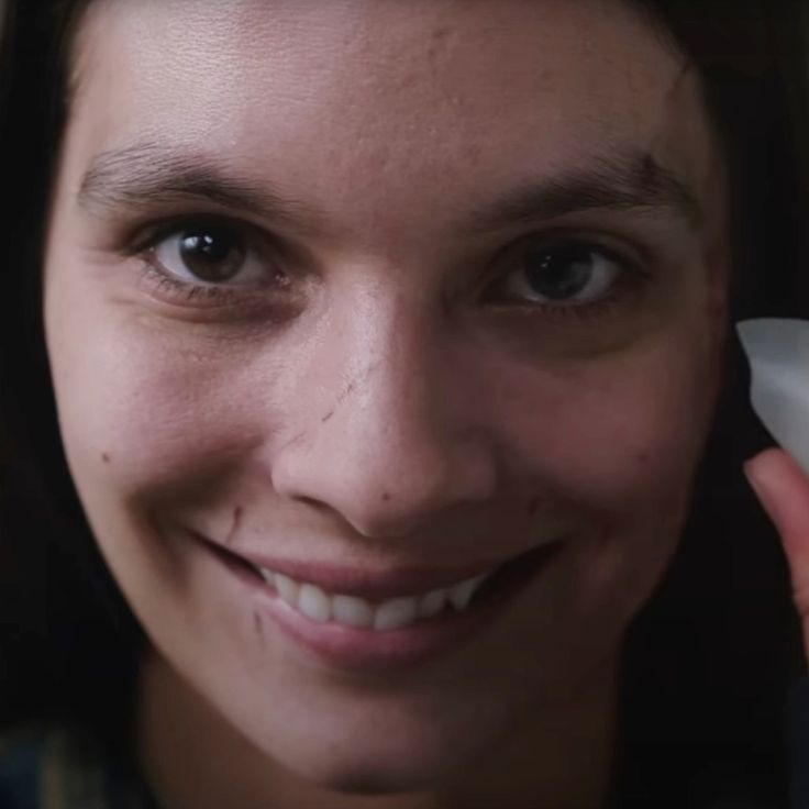 a close up of a person smiling at the camera