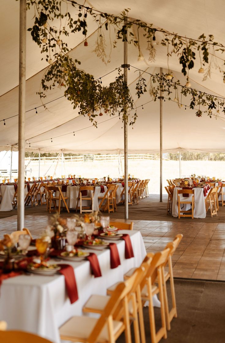 tables and chairs are set up under a tent