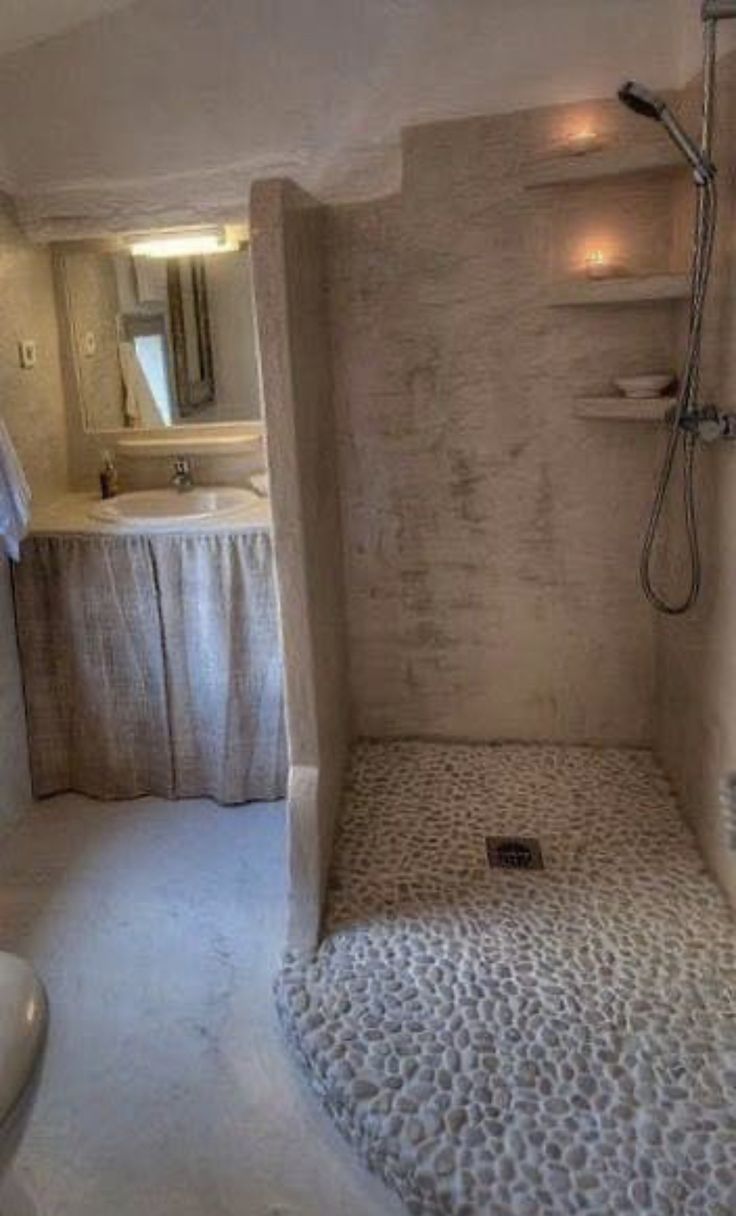 a bathroom with a shower, toilet and sink