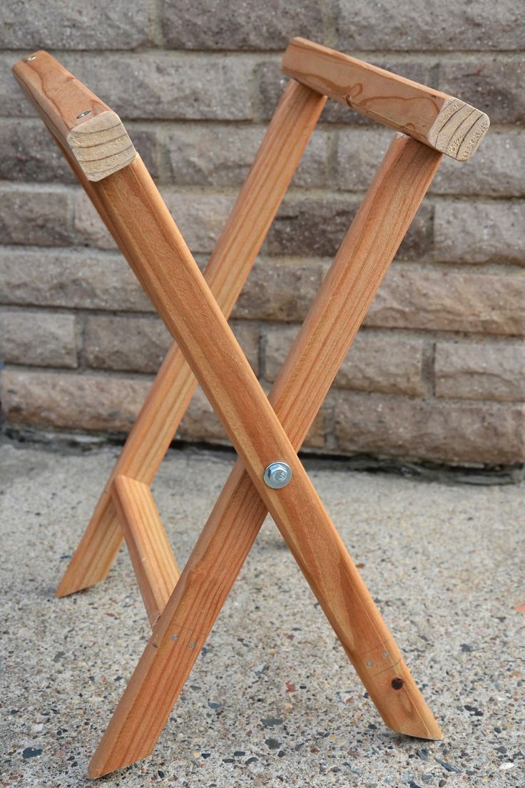 a wooden stool sitting on top of a sidewalk