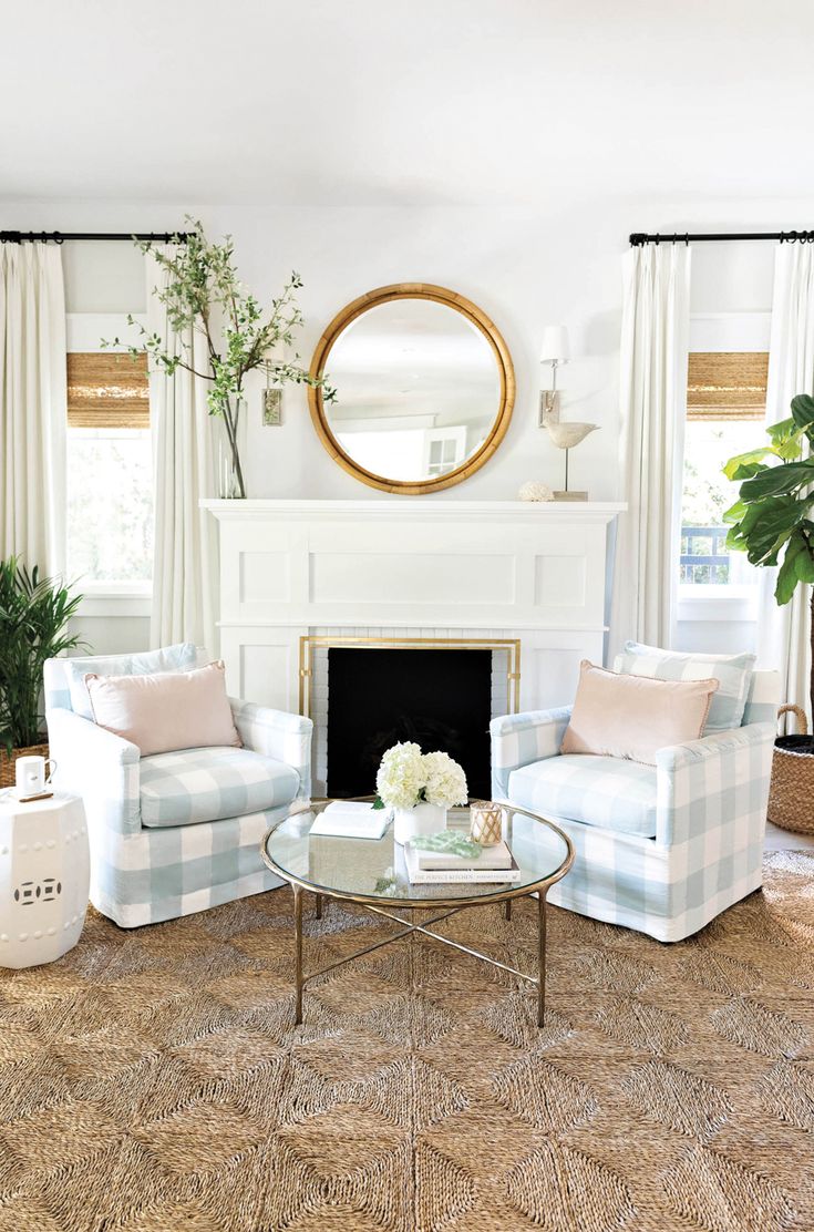 a living room filled with furniture and a fire place in front of a mirror on the wall