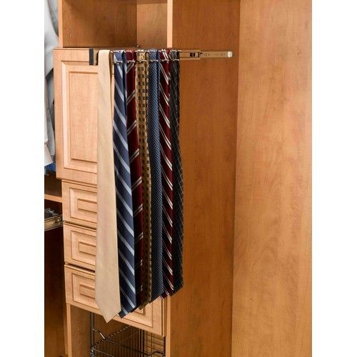 an organized closet with ties hanging from it's door and drawers on the other side