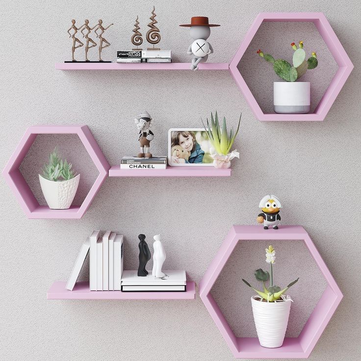 three hexagonal shelves with plants, books and pictures on them in different colors