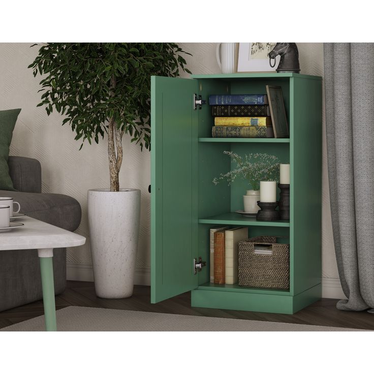 a green cabinet with some books on it and a potted plant in the corner