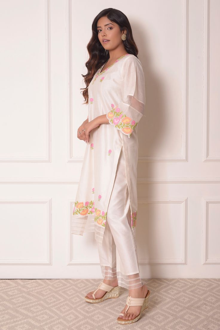 Off white chanderi kurta in floral applique work with sheer panels. Paired with sheer hem pant and dupatta.
Component: 3
Pattern: Embroidered
Type Of Work: Floral applique work
Neckline: V neck
Sleeve Type: Flared sleeves
Fabric: Chanderi, Organza
Color: White
Other Details: 
Pink dupatta with canopies
Occasion: Mehendi and Haldi - Aza Fashions Applique Kurta, V Neck Kurta, Pink Dupatta, Applique Work, Kurta Set For Women, How To Hem Pants, Canopies, Fashion App, Kurta Set