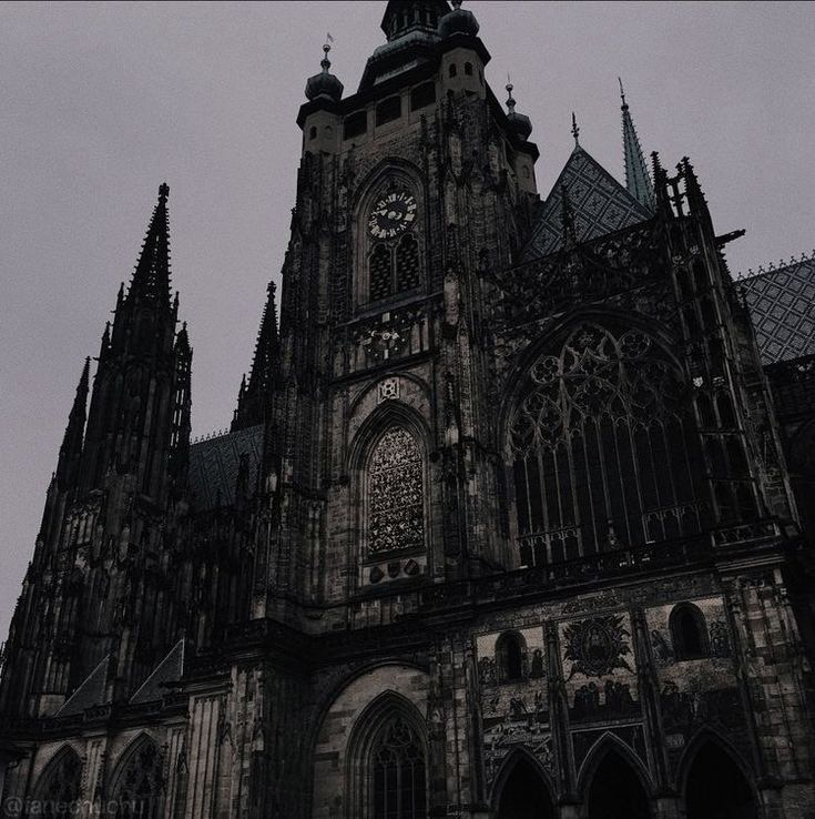 an old cathedral with steeples and clocks on it