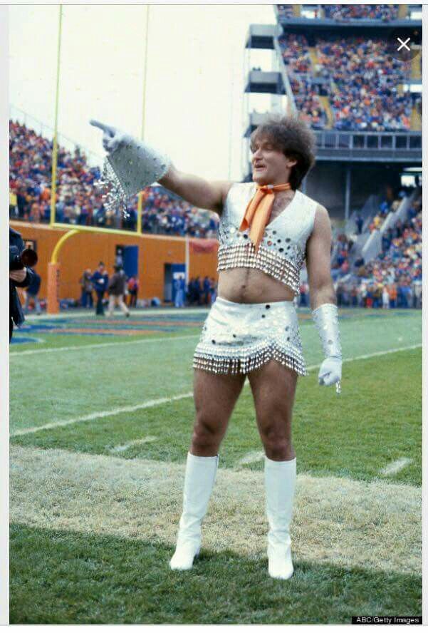 a man dressed as a cheerleader on a football field