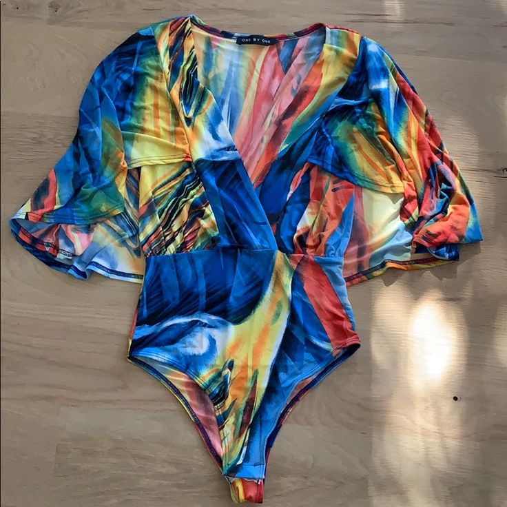 Colorful Bodysuit With Longer Sleeve Never Worn, Couldn��’t Return Because I Removed Tags Trendy Stretch Multicolor Bodysuit, Multicolor Fitted V-neck Swimwear, Multicolor V-neck Party Swimwear, Spring Multicolor Stretch Bodysuit, Summer Multicolor Bodysuit For Beach Season, Multicolor One-piece Bodysuit For Vacation, Multicolor Short Sleeve Tops For Poolside, Printed Multicolor Bodysuit For The Beach, Multicolor Summer Bodysuit For Beach Party