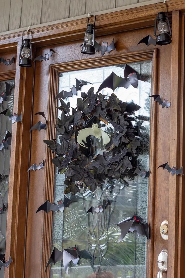 a glass door decorated with bats and flowers