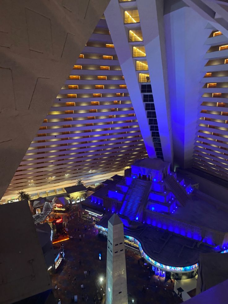 an aerial view of the inside of a building with lights on and around it at night