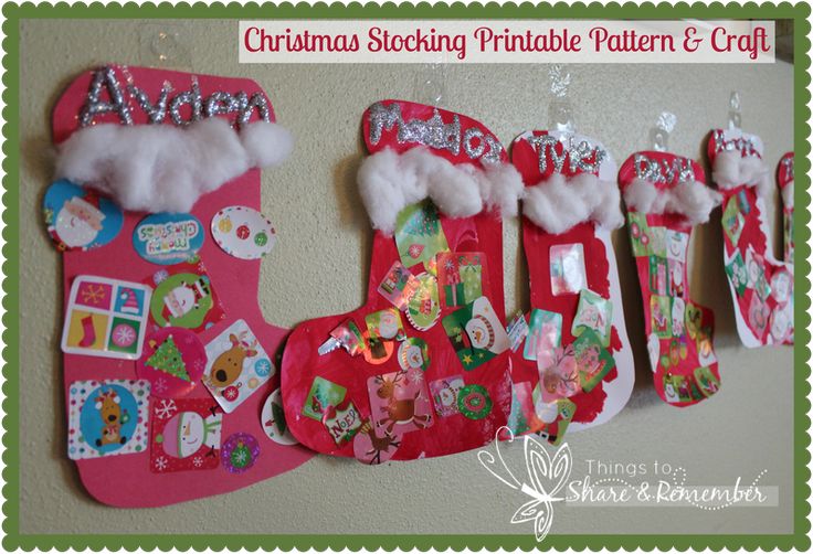 christmas stockings are hanging on the wall and decorated with paper mache designs, snowflakes, and other decorations