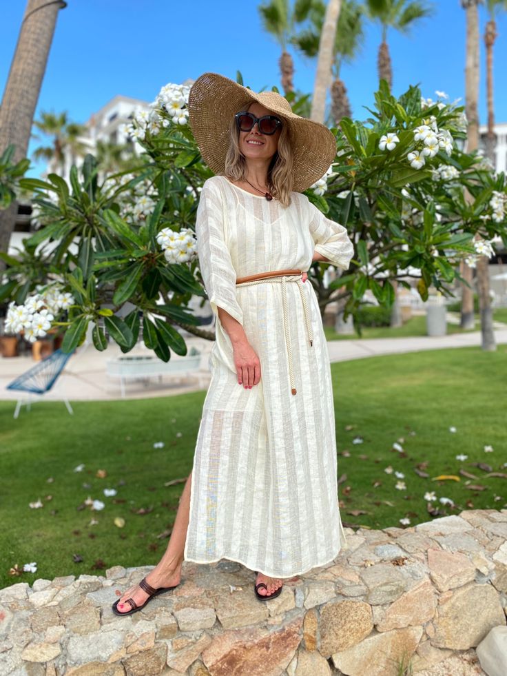 Evoke your inner goddess in our delightful Athena Kaftan. Perfect for an island resort vacation, this breezy linen kaftan will be a great cover-up solution if you want to throw something on top of your bikini. Or wear it over a slip dress, over shorts, even jeans. Athena Kaftan is one size. Due to its breathable transparency, you can purchase it together with our Leah cotton slip dress, that is available in sizes S, M, L. And then it can be worn as a maxi linen dress. Belt it up, if you like, an White Bohemian Beach Dress For Resort Season, Chic Long Kaftan For Beach, Spring Beachwear Beige Kaftan, Resort Season Vacation Tunic Cover-up, Beige Spring Kaftan For Beachwear, Chic Linen Tunic For Vacation, Beige Spring Beachwear Kaftan, Flowy Beige Kaftan For The Beach, White Tunic Cover-up For Vacation