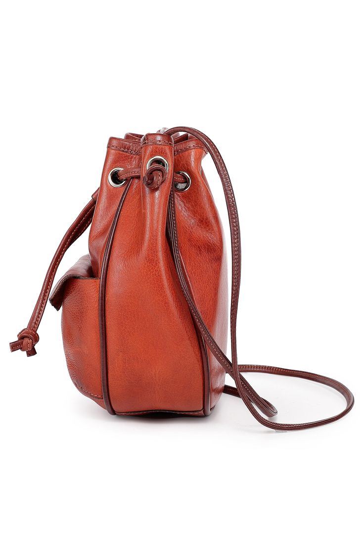 Crafted from vegetable-dyed leather, this classic bucket bag features a crossbody strap for hands-free wear. Drawstring closure Textile with leather trim Imported Classic Crossbody Bucket Bag In Soft Leather, Cognac Bucket Hobo Bag With Leather Lining, Classic Soft Leather Crossbody Bucket Bag, Leather Satchel Bucket Bag In Light Brown, Cognac Bucket Bag With Detachable Strap For Daily Use, Cognac Leather Bucket Shoulder Bag With Leather Handles, Classic Leather Bucket Bag In Cognac, Cognac Bucket Bag For Daily Use, Cognac Leather Bucket Bag