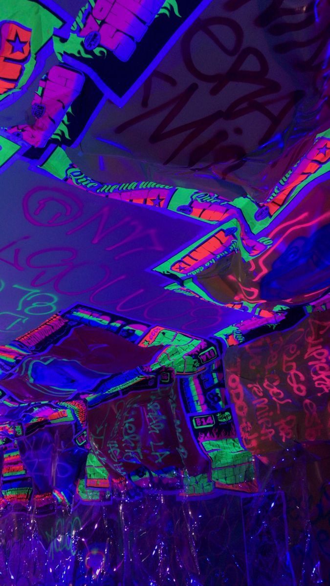 the ceiling is covered in neon colored graffiti