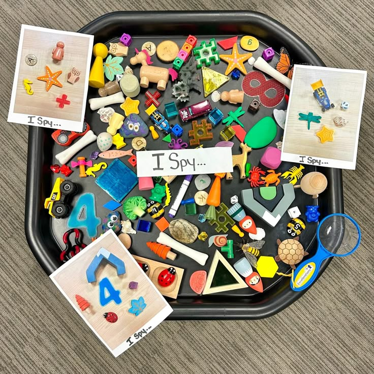 a tray filled with lots of toys and magnets on top of a wooden floor