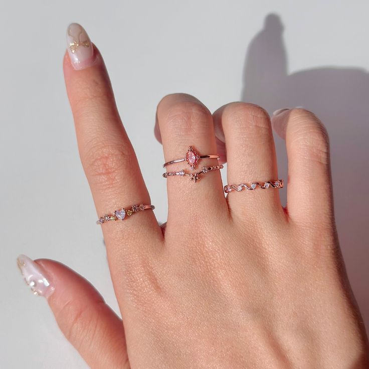 Complete your dreamy ring stack with the Pink Wave Ring! Designed to go with any style, this ring will add a touch of elegance and uniqueness to your everyday look. Don't miss out on this must-have piece for your jewelry collection. 📌 Please Note: When adjusting the ring, please squeeze or expand the ring body slowly and gently. 💎 Materials: 14k Rose Gold Electroplated - more durable than regular platings Cubic Zirconia 📐 Size: Adjustable Open Design - Size 5+ Rosa Gold, Wave Ring, Ring Stack, Open Design, Flower Heart, Diamond Crystal, Pink Tourmaline, Ring Bracelet, Artisan Jewelry